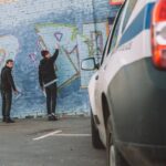 back-view-of-vandals-painting-graffiti-on-wall-po-2024-11-18-13-45-08-utc