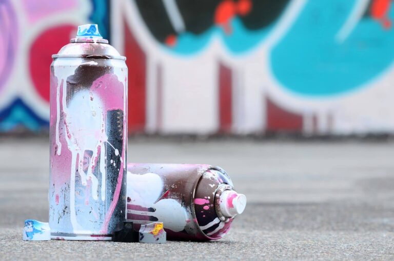 several-used-spray-cans-with-pink-and-white-paint-2023-11-27-05-23-47-utc